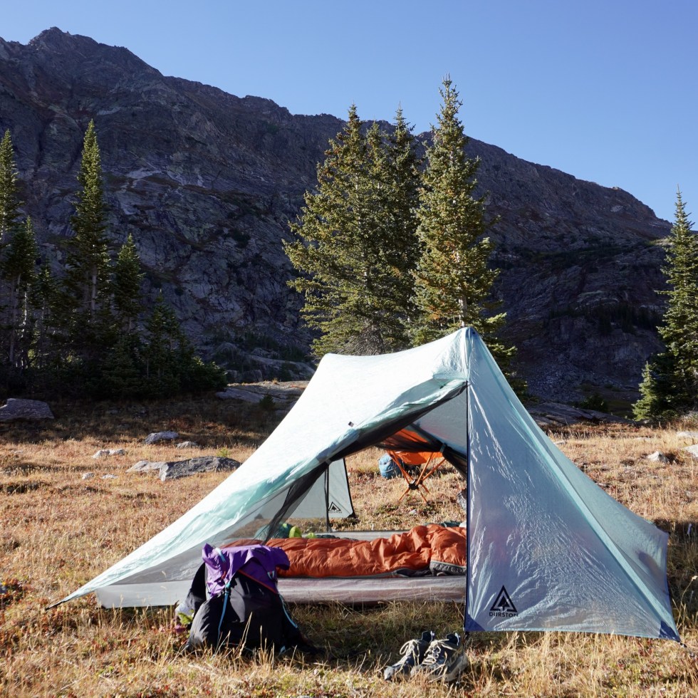 tent in meadow in front of mountain